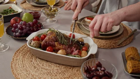 Close-Up of Man Carving Roasted Meat for Festive Family Dinner Celebration Stock Footage 340336867