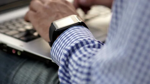 Close up of man check his smart watch with laptop Stock Footage 65020583