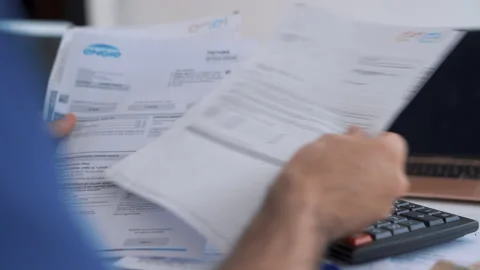 Close up Man checking bills and calculating expenses, taxes. Accountancy Stock Footage 160189561