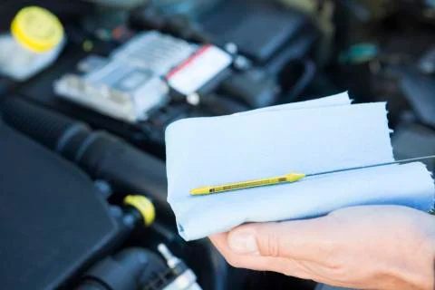 Close-Up Of Man Checking Car Engine Oil Level On Dipstick Stock Photos