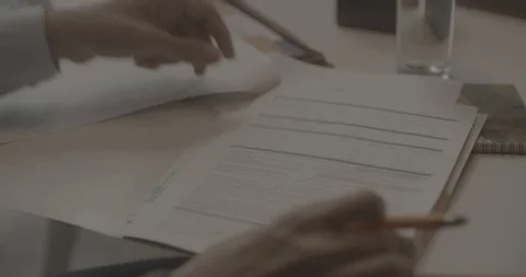 Close up of a man checking a form - Shot on RED 5K Stockbeeldmateriaal 113605103