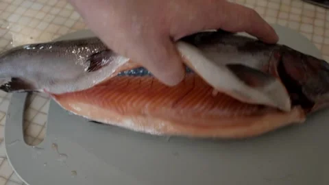 Close-up of a man checking the freshness of fish before cooking in the kitchen a Stock-Footage 266670866