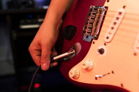 Close up man is checking his guitar before playing. The idea of photo musical Stock Photos
