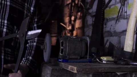 Close-up of a man checking the result of work on a sharpener. copy space 動画素材 137970761