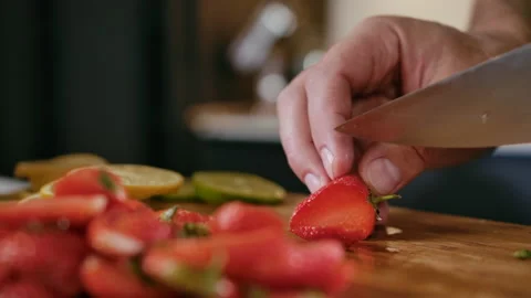 Close-up Man Chef Cuts Fresh Fruits Strawberry on Wooden Cutting Board Cooking Stock Footage 144721652