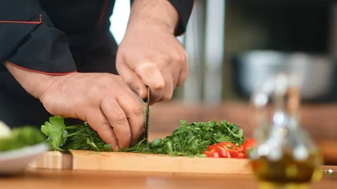 Close-up man chef hands cutting fresh greens and red paprika. Wide shot on RED Vídeos de archivo 124156631