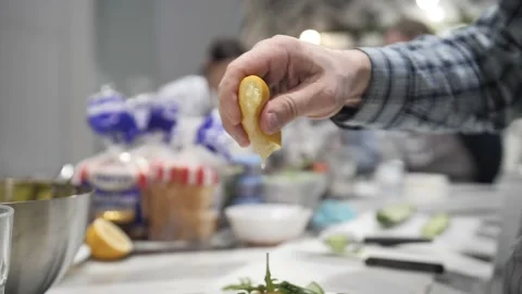 Close-up Man Chef Squeezes a Half Cut Lemon Stock Footage 171462903