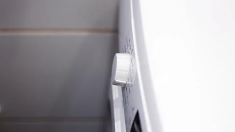 Close Up Of Man Choosing Cycle Program On Washing Machine . Stock Photos