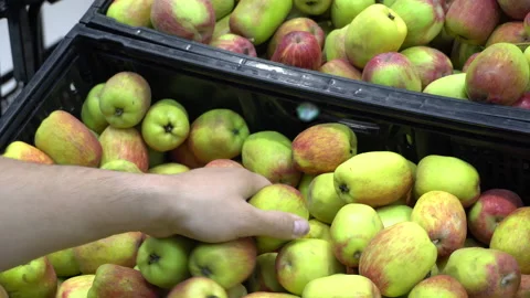 Close-up of a man choosing national apple of Peru in the supermarket Stock Footage 141014929
