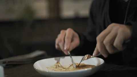 Close-up of a Man Chopping Dinner at a Night Cafe Stock Footage 97660960
