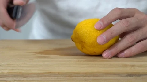 Close up of a man chopping lemon in a kitchen Stock Footage 113515461