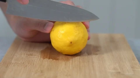 Close up of a man chopping lemon vegetables on chopping board Video stock 113629013