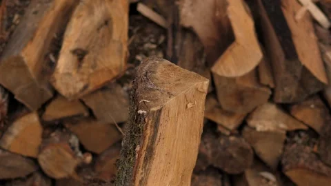 Close-up of a man chopping wood with an axe in the backyard of a house. Stock Footage 295189027