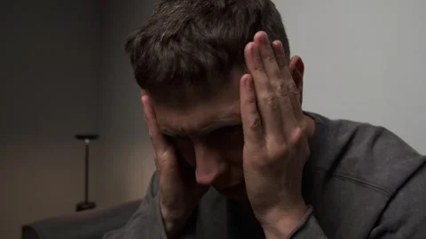 Close up man chronic headache holding head both hands authentic home lifestyle Stock Footage 315411593