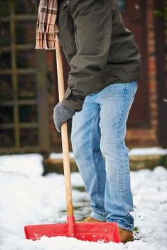 Close Up Of Man Clearing Snow From Path Stock Photos