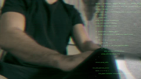 Close-up of man coding with green text overlay. Cybersecurity and data Stock Footage 286073379