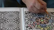 Close-Up Of Man Coloring A Mandala In Adult Coloring Book Stock Footage