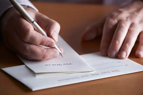 Close up of man completing last will and testament Stock Photos