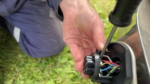 Close-up man connects wires to the devices motor Stock Footage 331569331