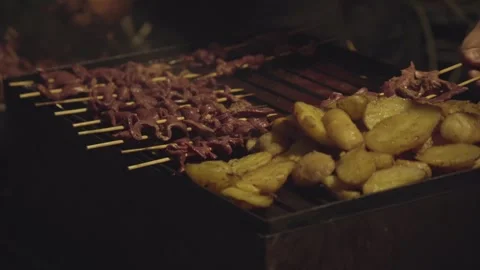 Close up of a man cooking traditional Peruvian food "anticuchos" Stock Footage 272506437