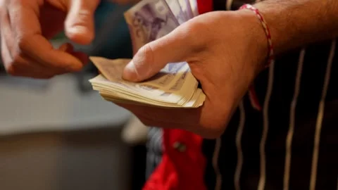 Close-Up of Man Counting British Pound Notes Stock Footage 304545699