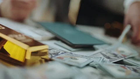 Close up of man counting cash and using digital tablet at office desk with .. Stock Footage 337411322