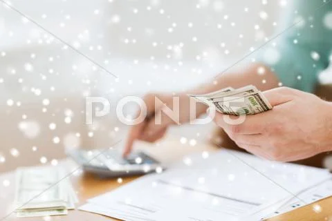 Close Up Of Man Counting Money And Making Notes