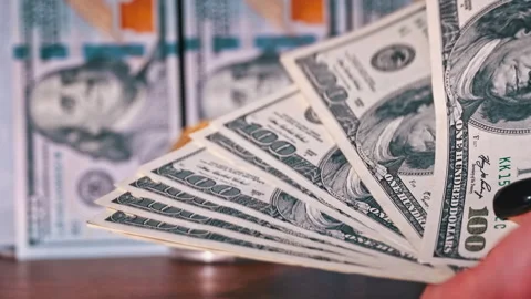 Close-up of Man Counting Out Dollars for Bitcoins Stock Footage 260480432