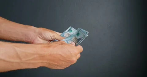 Close-up. Man counts Dominican republic money in hands. Stock Footage 189367262