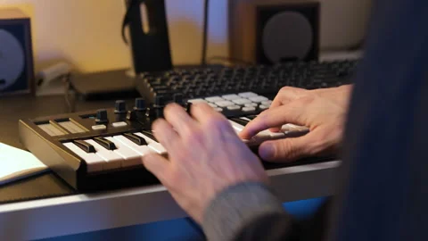 Close-up of man creating track with MIDI keyboard Stock Footage 295877037