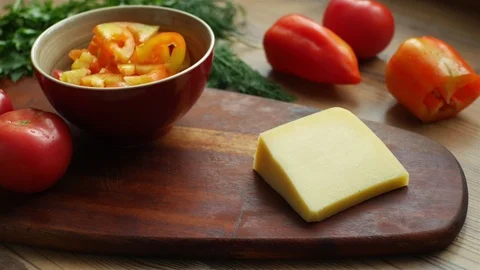 Close-up man cuts cheese into vegetable salad Stock Footage 116171612
