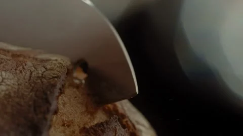Close-up of a man cuts crispy homemade rustic fresh bread with a sharp knife Stock Footage 168822512