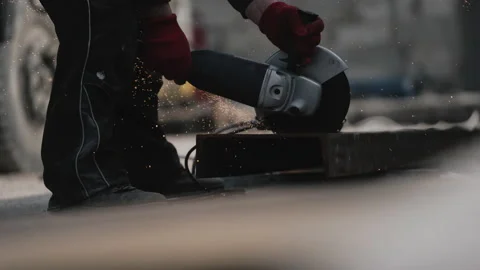 Close up of a man cuts a metal with a cutting wheel at the factory Stock Footage 152059244