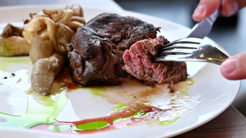 Close up man cutting fillet mignon stake with mushroom Stock Footage 202464068