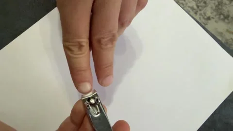 Close up man cutting fingernails with metal nail clipper. Personal hygiene and Stock Footage 336978955