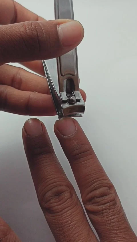 Close up of a man cutting his fingernails using nail clippers Stock Footage 280635260