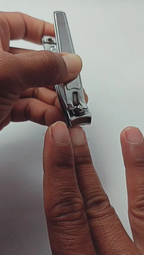 Close up of a man cutting his fingernails using nail clippers Stock Footage 280635343