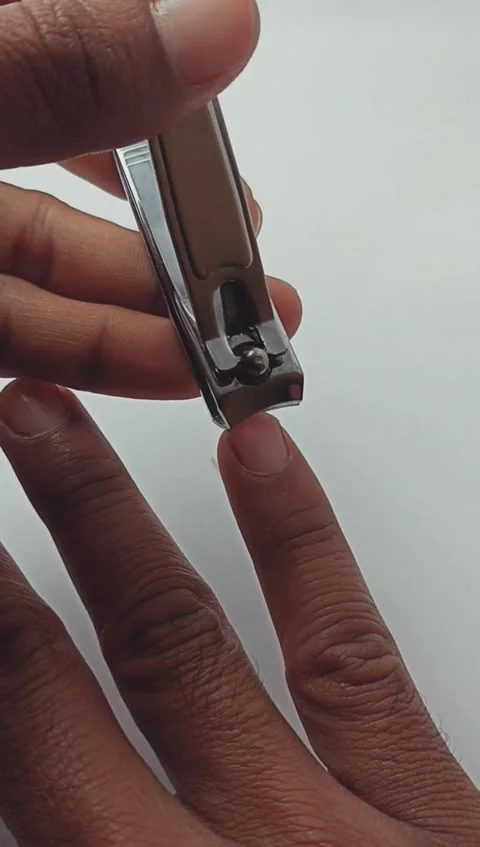 Close up of a man cutting his fingernails using nail clippers Stock Footage 280635417
