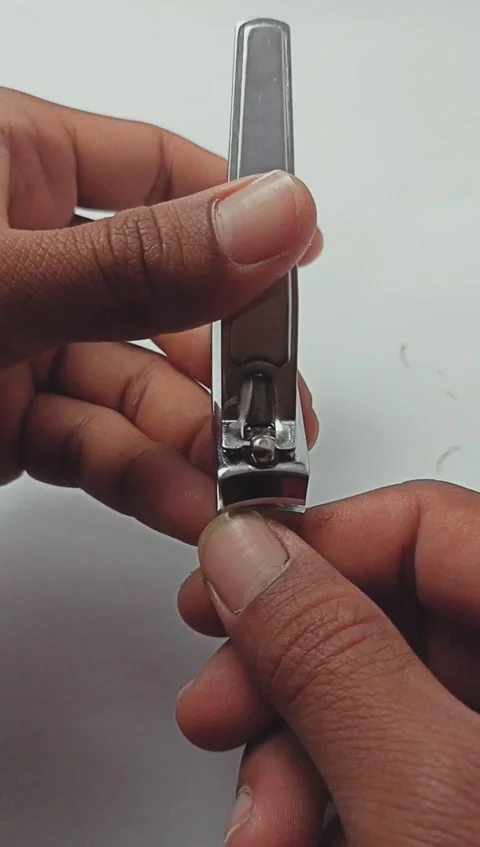 Close up of a man cutting his fingernails using nail clippers Stock Footage 280635419