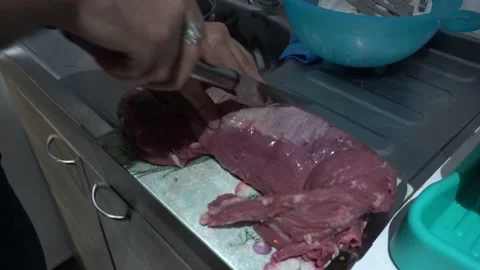 Close-up of a man cutting meat with a knife to prepare the grill with his hands Stock-Footage 155788361