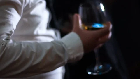 Close up of a man dancing holding a glass of wine and a bottle of beer Stock Footage 104661089
