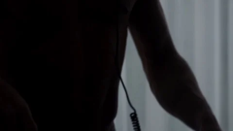 Close up of man in dark room dancing with headphones in slow motion , Portugal Stock Footage 129065887