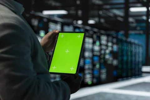 Close up of man in data center using green screen tablet Stock Photos