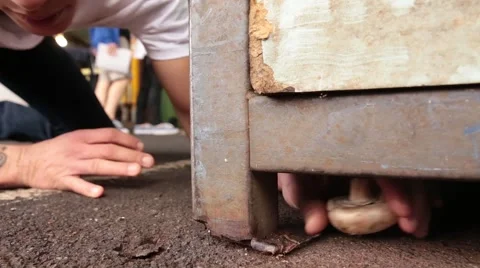 Close-up of a Man Discovering A Mushroom under Table at Market Stock-Footage 40029885
