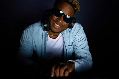 Close-up of a man at the DJ console. Smiling. The head is tilted Stock Photos