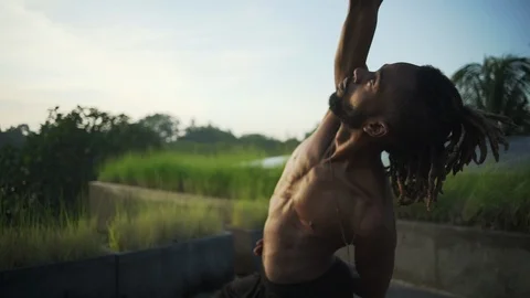 Close up man do bikram yoga on roof with solar battery sunset rapid slow motion Stock Footage 89721658