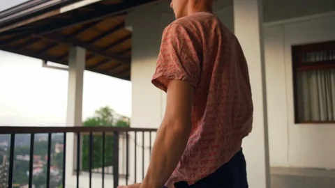 Close up man do breathing exercises at balcony sunrise rapid slow motion Video stock 86649979