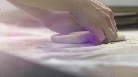 Close-up of a man doing pizza, a man kneading a dough in slow motion Video stock 75466539