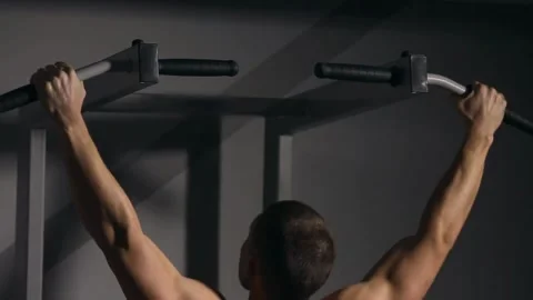 Close-up of Man Doing Pull-ups in the Gym, Showing Muscles Stock Footage 314303158
