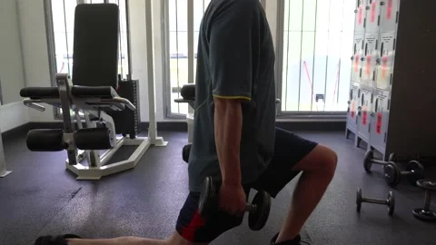 Close-up of a man doing push-ups with dumbbells on his hands in the gym Stock Footage 164588441